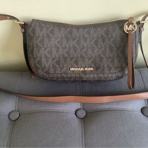 Slightly used Michael Kor’s half moon mini crossbody bag.